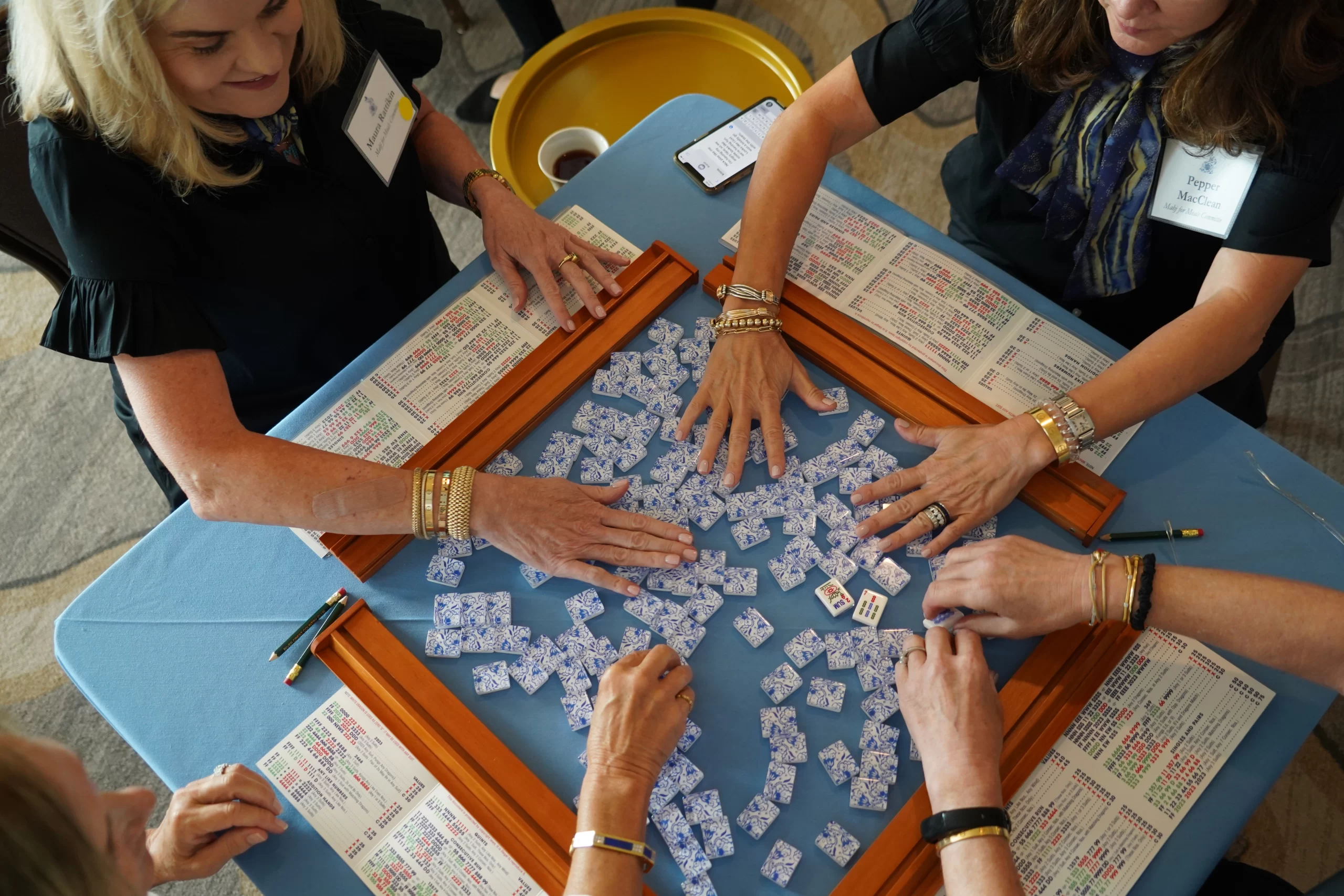 Women playing Mah Jongg game