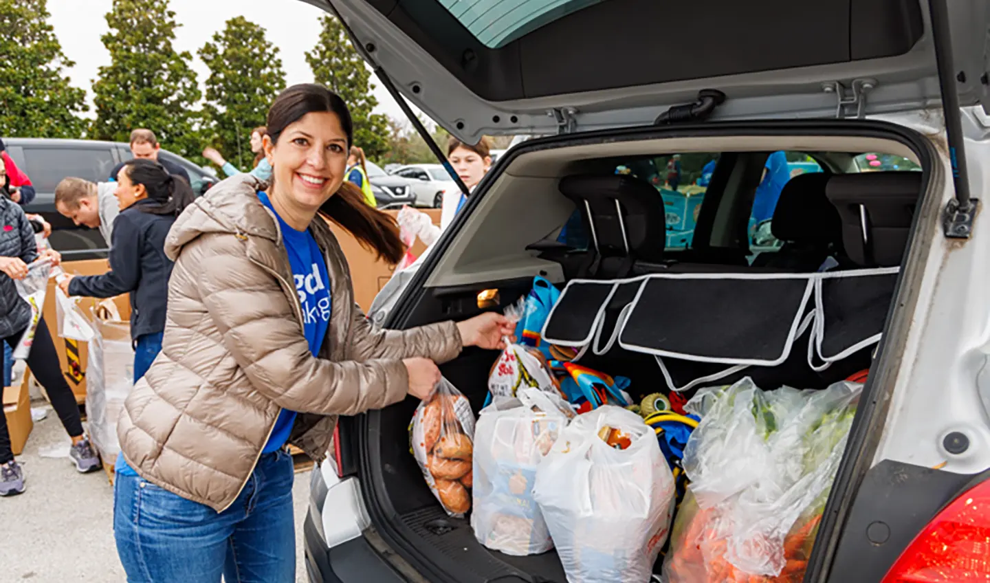 Volunteer loading car at North Food Bank